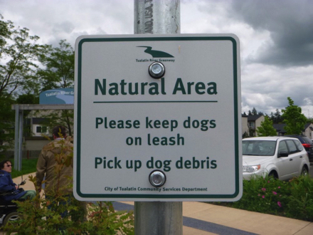 Sign - natural area - please keep dogs on leash - pick up dog debris